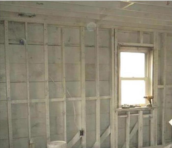 primed white walls after demolition in a garage