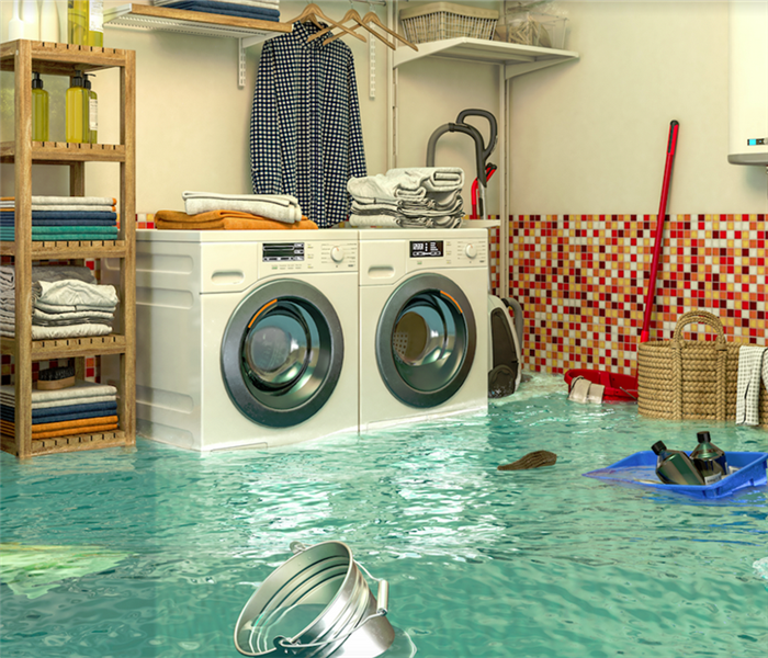 a flooded laundry room with water covering the floor